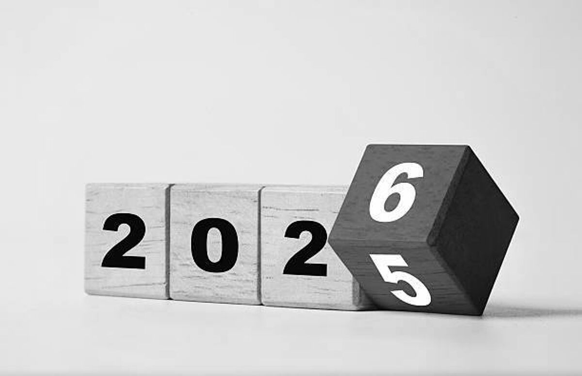 Flipping of 2025 to 2026 on wooden block cube for preparation new year change and start new business target strategy concept.